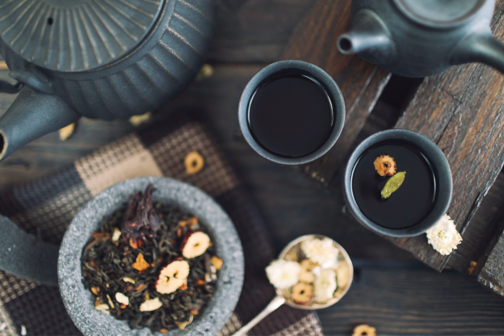 Tea pot, tea cups and tea leaves