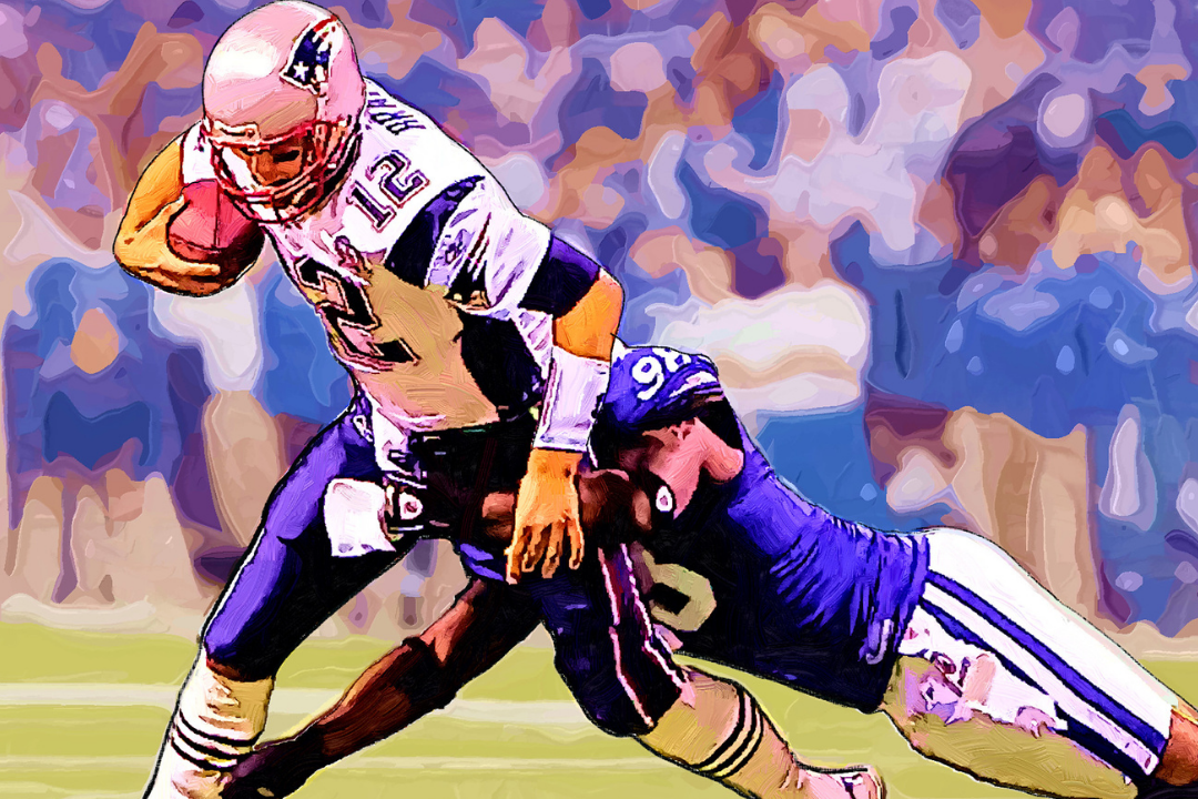 NFL player Tom Brady being tackled. Image by Jack Kurzenknabe