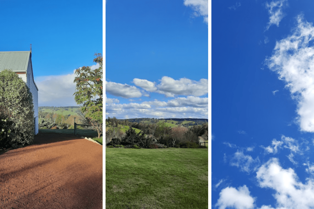 View from a country driveway, green hills and trees, blue sky with clouds