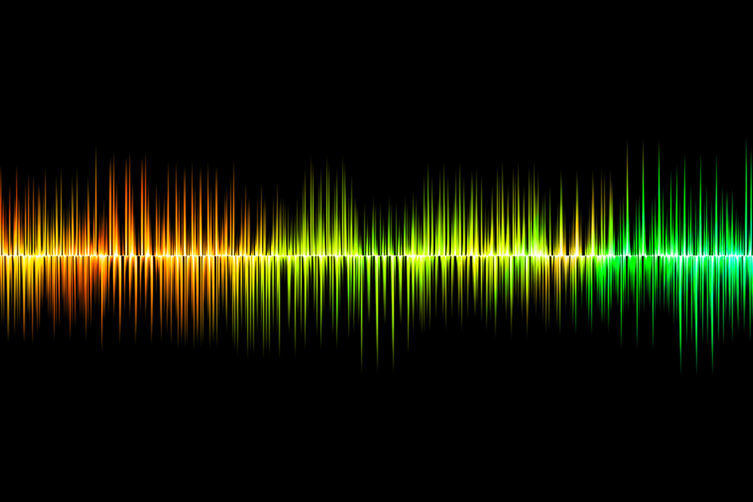 Orange, yellow and green light waves spiking up and down.