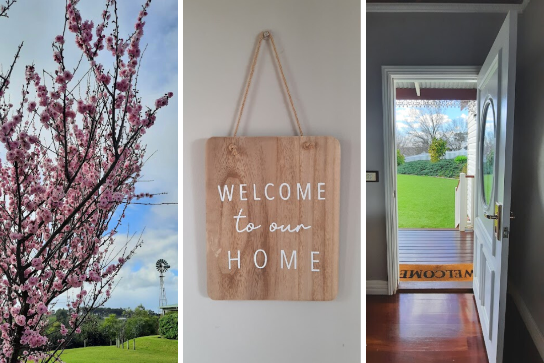 Flowering plum trees, a welcome home sign and front door view from a country cottage.