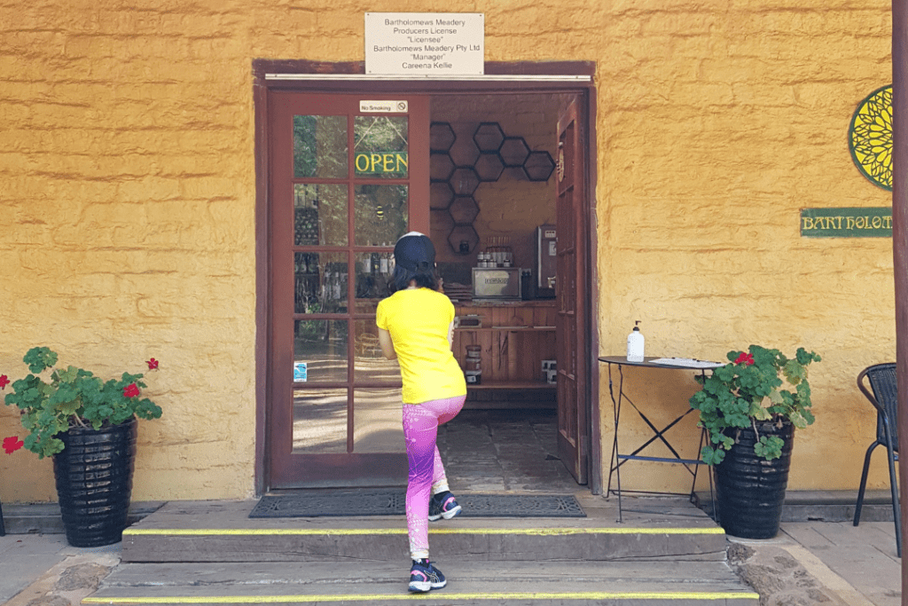 Child walking up steps into brick building Batholomews Meadery