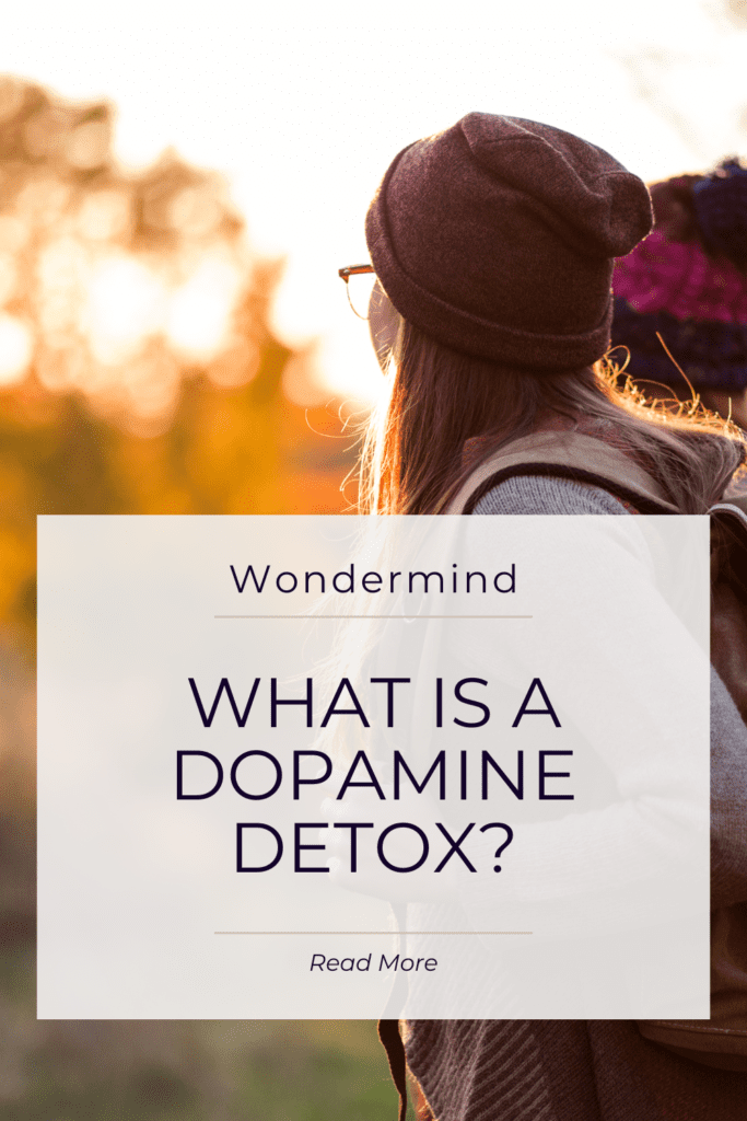 Two people hiking looking towards the sunset. Text: Wondermind What is a dopamine detox, read more