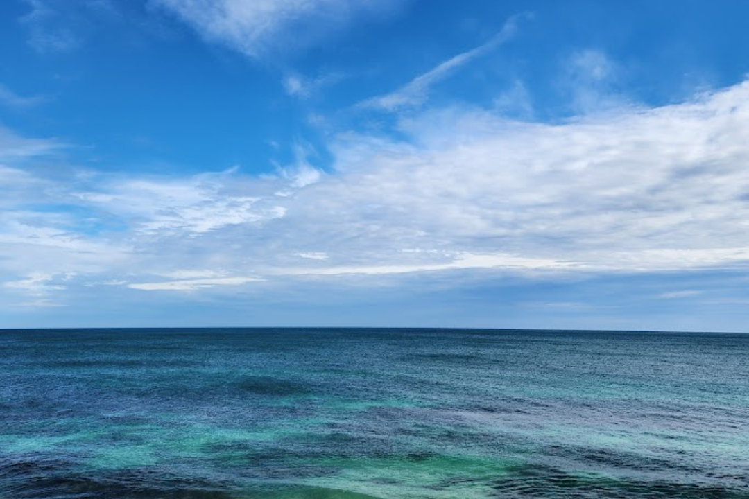 Blue sky with clouds and ocean