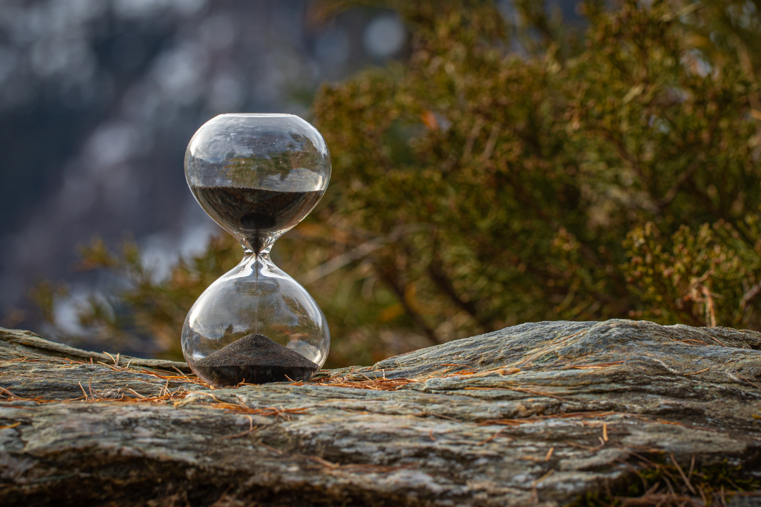 Hourglass on a rock in the wild.